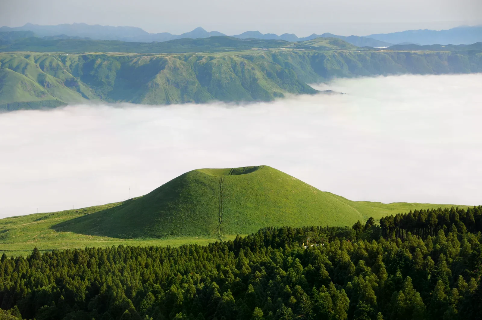 綠色山丘與雲海，呈現阿蘇地區的草原山景氛圍