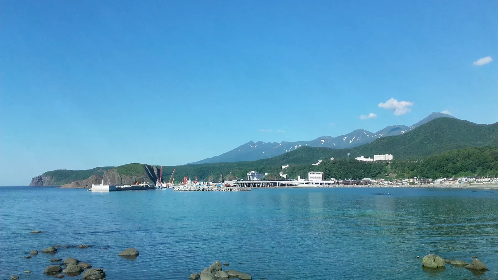 海灣岸邊的宇登呂港口、聚落與遠方山脊